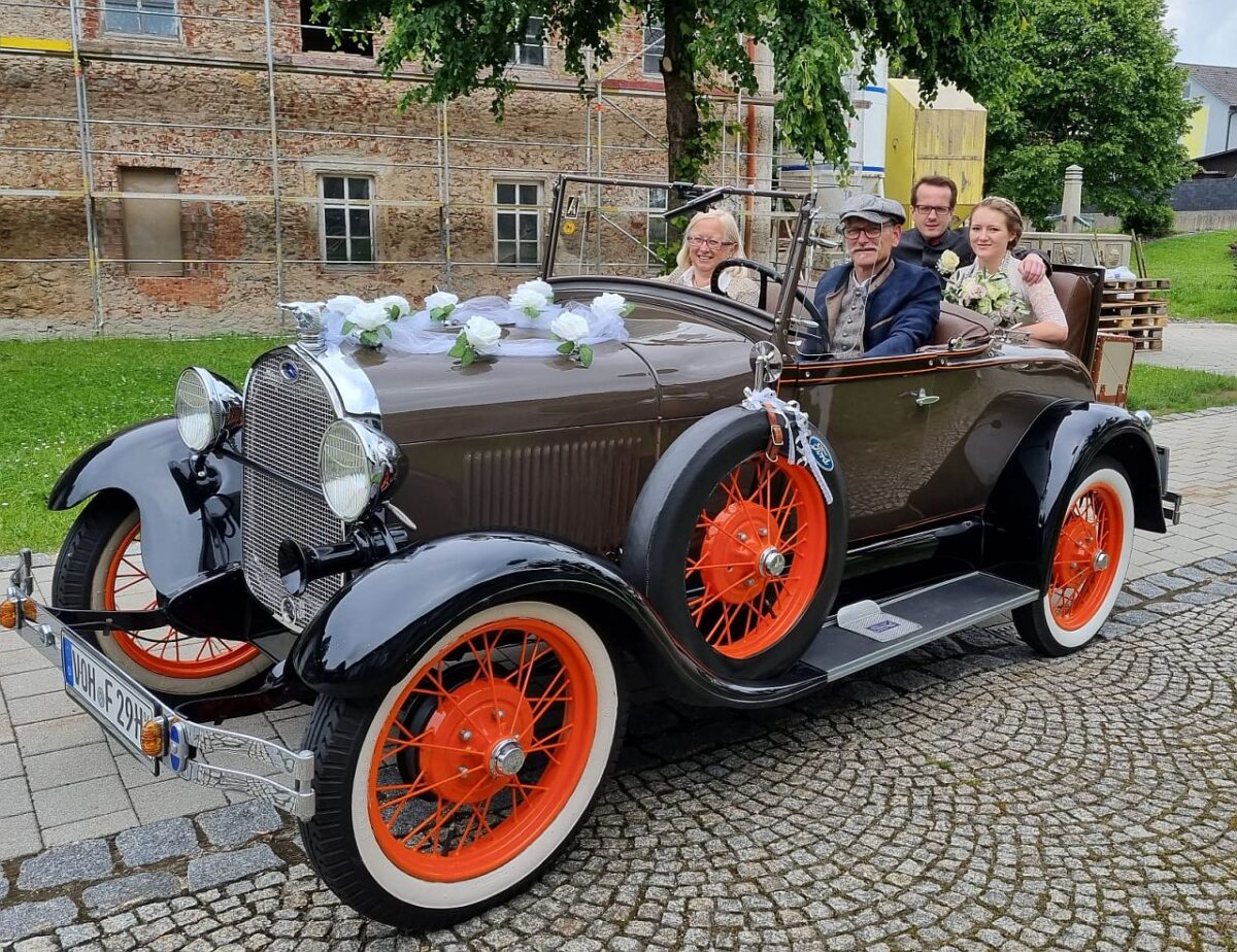 Auf dem Rücksitz des Ford Henry Modell A aus dem Jahr 1929 fährt das Brautpaar Franziska Eger und Christoph Striegl am Waldthurner Rathaus vor. Foto: Franz Völkl